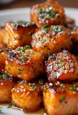 Air Fryer Honey Garlic Salmon Bites served on a plate with garnishments