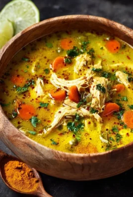 Bowl of anti-inflammatory turmeric chicken soup with herbs and spices
