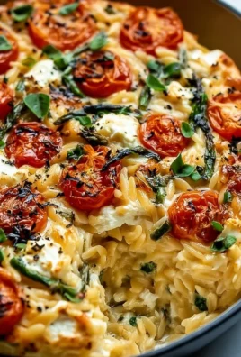 Delicious baked feta orzo served in a bowl with fresh herbs and tomatoes