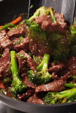 Delicious beef and broccoli stir-fry served on a plate with rice
