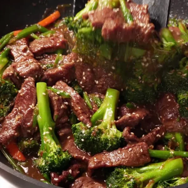 Delicious beef and broccoli stir-fry served on a plate with rice