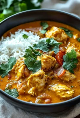 A delicious bowl of homemade chicken curry Indian recipe garnished with cilantro.