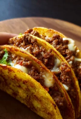 Delicious crispy ground beef tacos garnished with fresh ingredients
