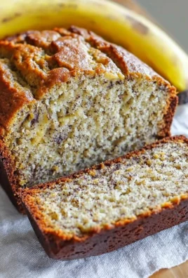 Loaf of homemade banana bread on a wooden cutting board