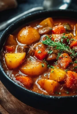 Bowl of Irish vegetarian stew with fresh vegetables and herbs.