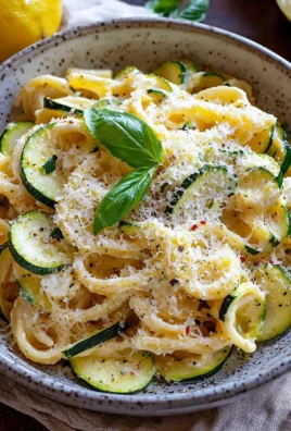 Lemon ricotta zucchini pasta served in a bowl with fresh herbs