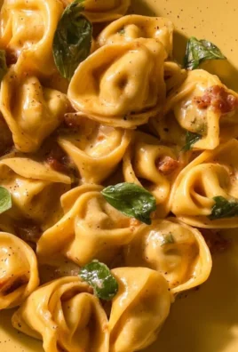 Delicious Marry Me Tortellini served with herbs and sauce on a plate.