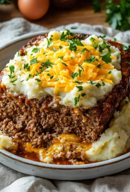 Homemade meatloaf served with mashed potatoes and cheese topping