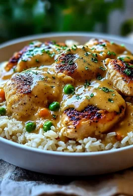 Delicious smothered chicken served over rice with a rich gravy