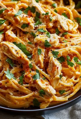 Delicious Bang Bang Chicken Pasta garnished with herbs and served on a plate.