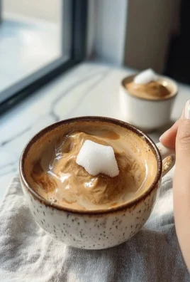 Delicious frozen fluffy coffee topped with whipped cream and cocoa powder