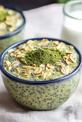 Bowl of matcha overnight oats topped with fruits and nuts