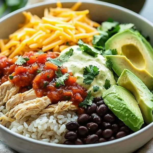 Slow cooker chicken burrito bowl with rice, beans, and toppings