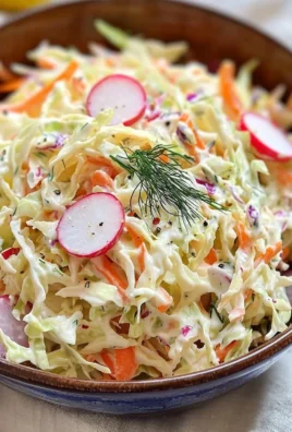 Bowl of super creamy coleslaw salad with fresh vegetables and dressing