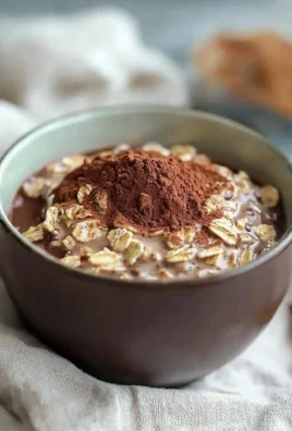 Delicious Tiramisu Overnight Oats in a glass topped with cocoa powder
